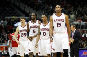 Dec 20, 2013; Atlanta, GA, USA; Atlanta Hawks shooting guard Kyle Korver (26) and small forward DeMarre Carroll (5) and point guard Jeff Teague (0) and center Al Horford (15) walk on the court against the Utah Jazz in the third quarter at Philips Arena. Mandatory Credit: Brett Davis-USA TODAY Sports